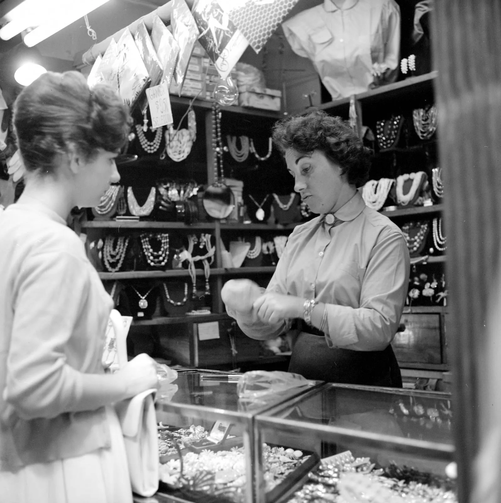 Mujer comprando joyas en tienda de Santiago ca. 1960.