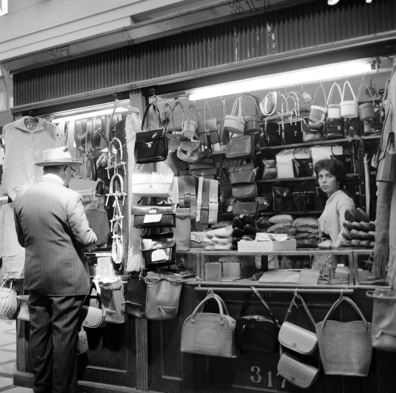 Hombre en el mostrador de una tienda en Santiago ca. 1960.